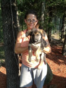 Sandy, Our Volunteer Holding a Male Puppy From the Carlie and Texoma Litter